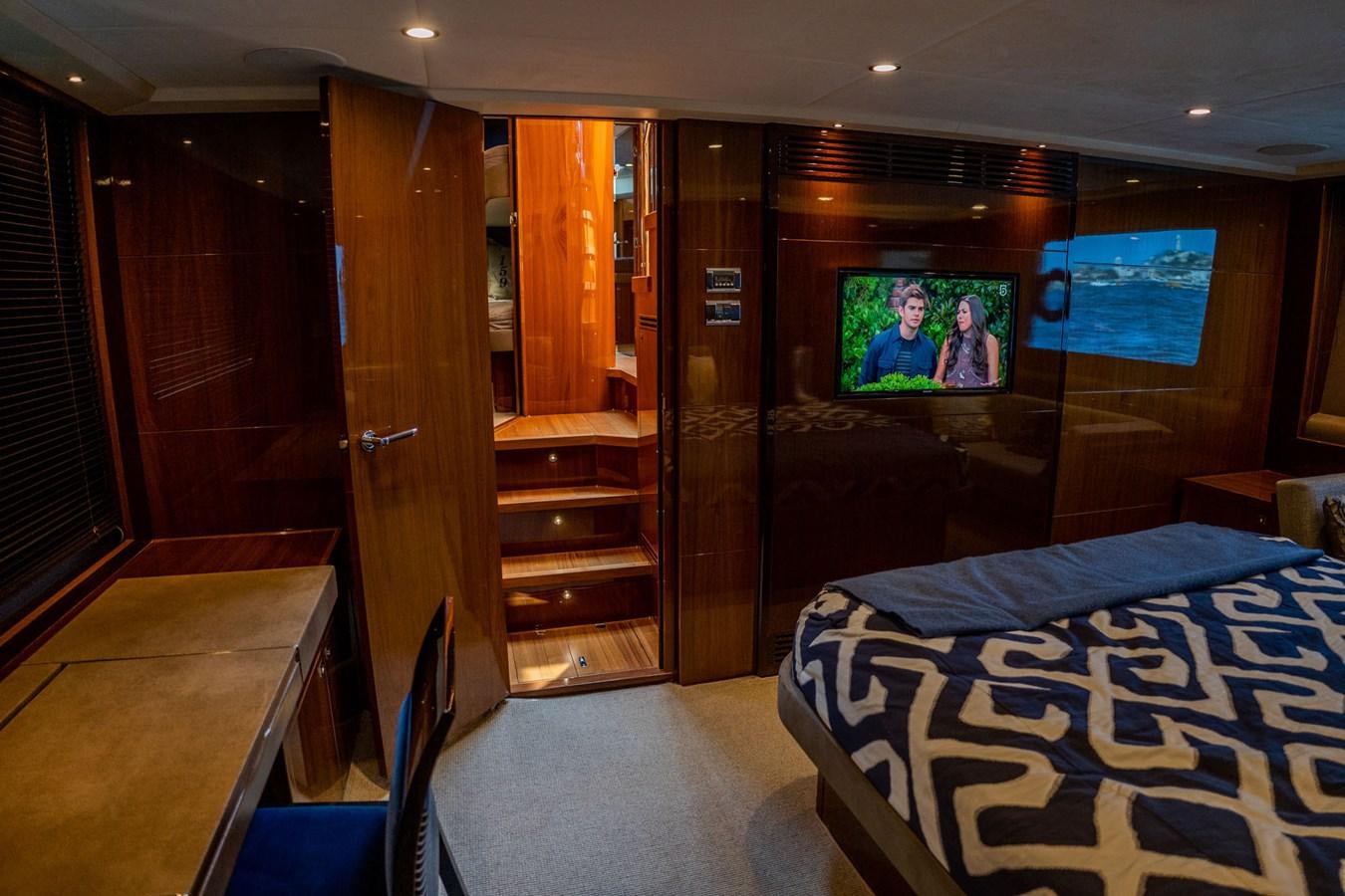 a room with a bed and a television aboard PICHOS III Yacht for Sale