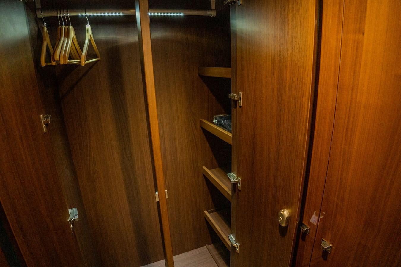 a wooden closet with wooden doors aboard PICHOS III Yacht for Sale