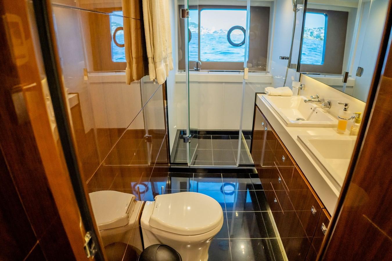 a bathroom with a tub sink and toilet aboard PICHOS III Yacht for Sale