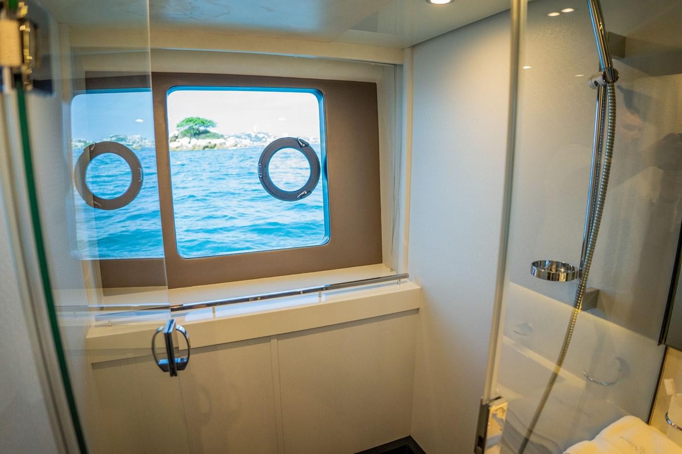 a bathroom with a large window aboard PICHOS III Yacht for Sale