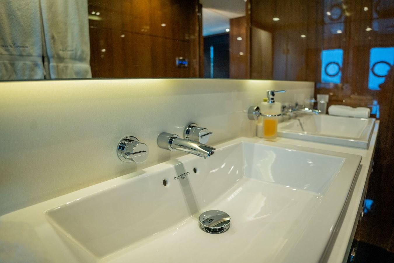 a bathroom with a bathtub sink and a mirror aboard PICHOS III Yacht for Sale