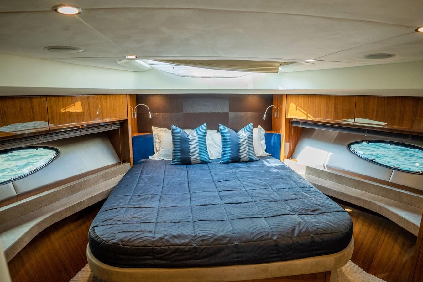 a room with a bed and a mirror aboard PICHOS III Yacht for Sale