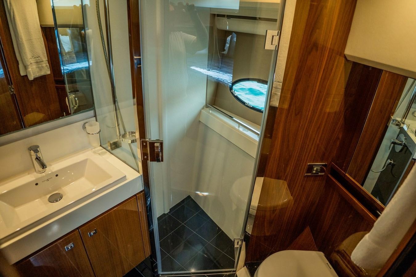 a bathroom with a glass shower aboard PICHOS III Yacht for Sale
