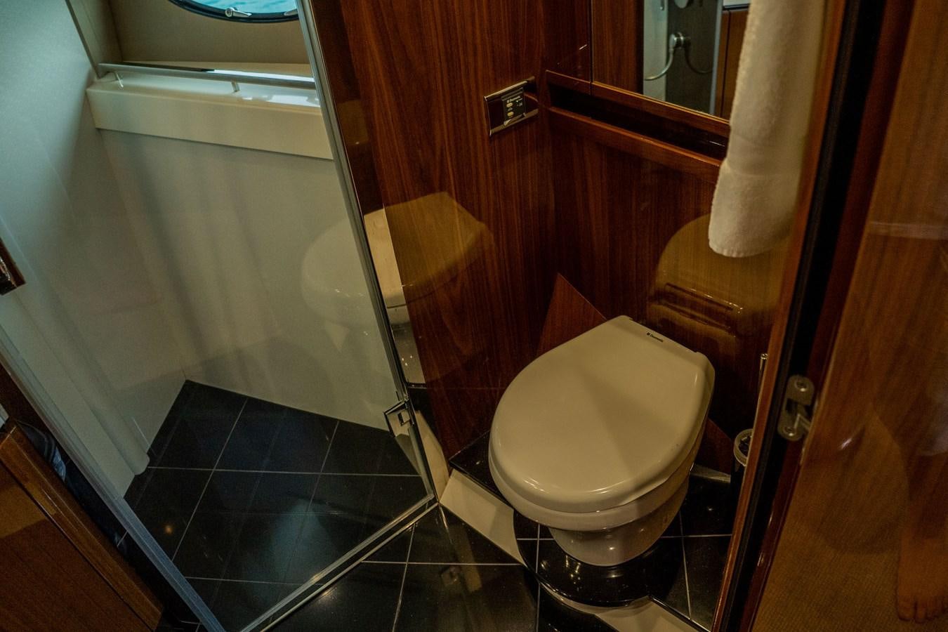a bathroom with a glass shower aboard PICHOS III Yacht for Sale