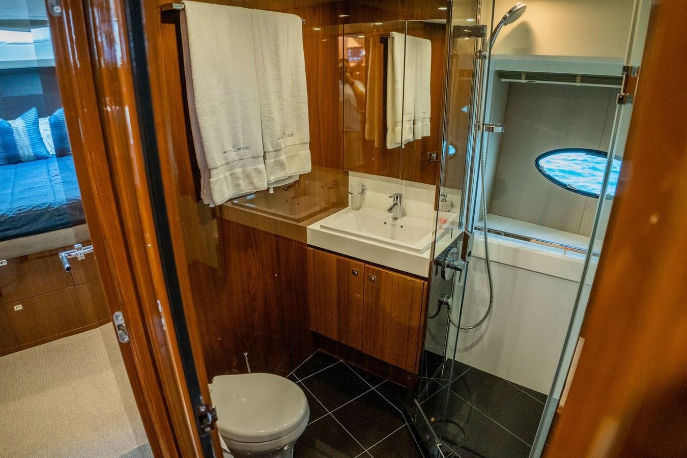 a bathroom with a glass shower aboard PICHOS III Yacht for Sale