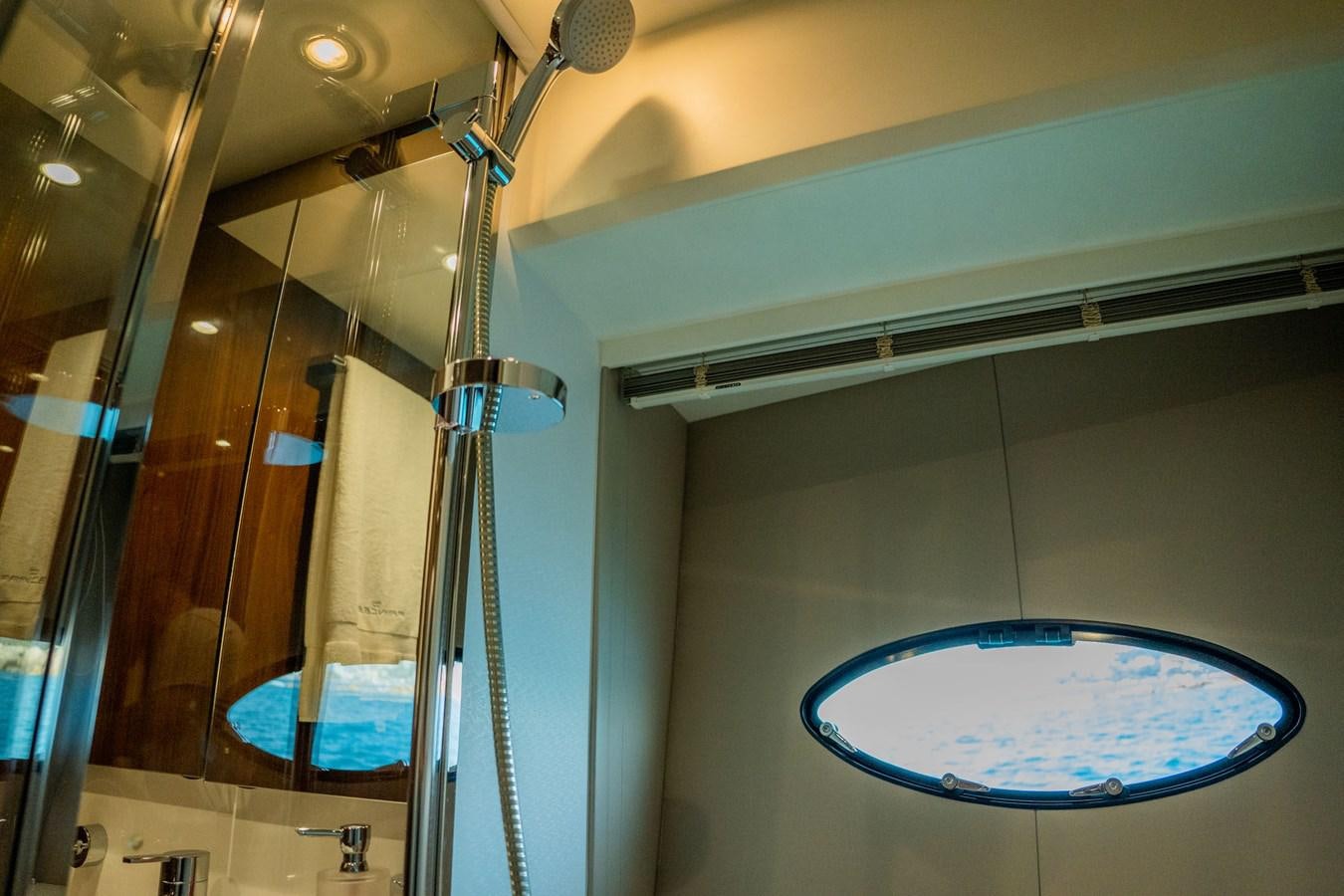 a bathroom with a glass shower aboard PICHOS III Yacht for Sale