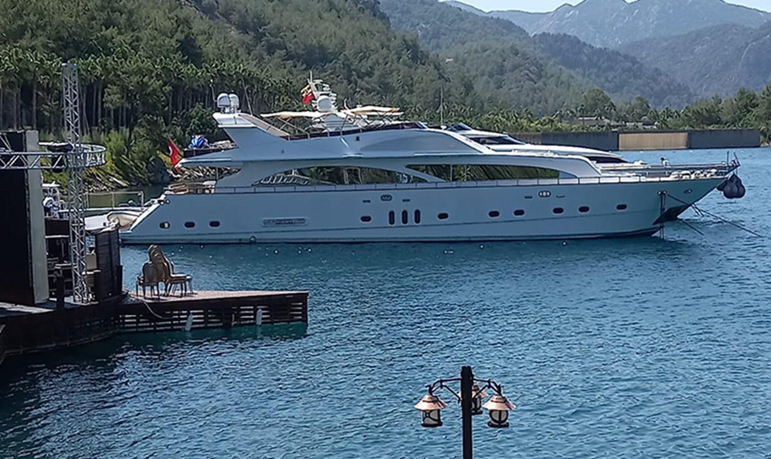 a large white yacht docked at a pier aboard AKSER Yacht for Sale