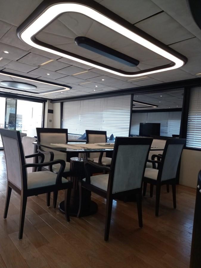 a room with a table and chairs aboard AKSER Yacht for Sale