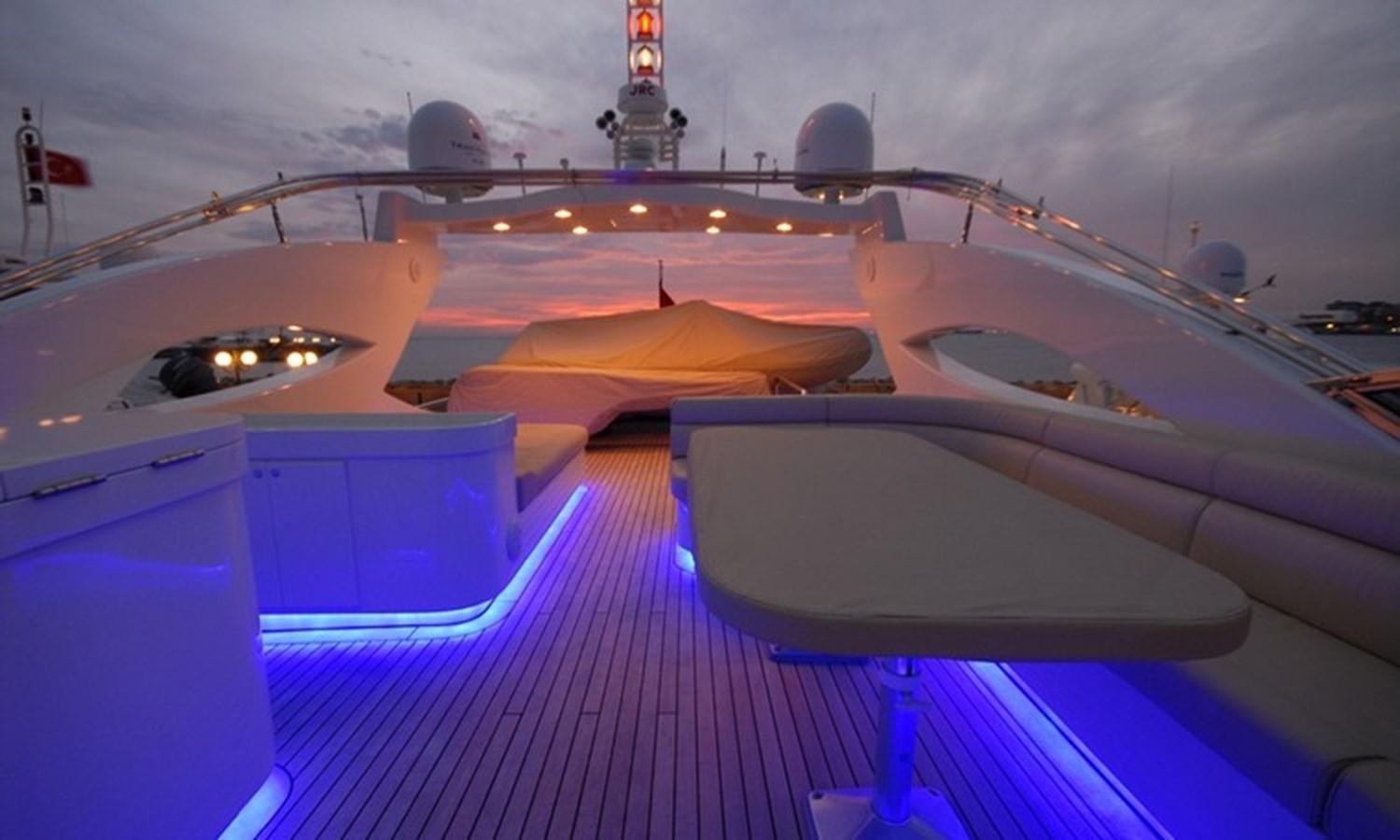 a boat with lights on the water aboard CORAL Yacht for Sale