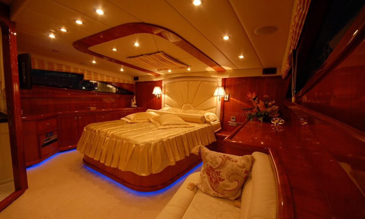 a room with a bed and a desk aboard CORAL Yacht for Sale