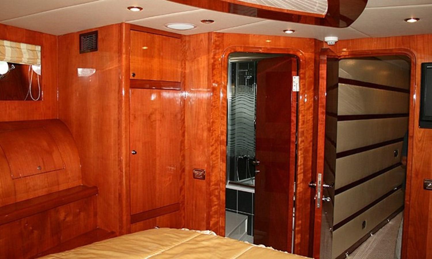 a room with wooden cabinets aboard CORAL Yacht for Sale