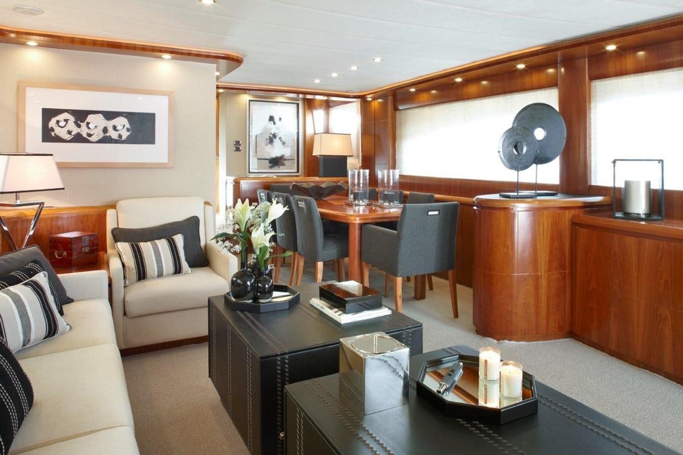 a living room with a dining table aboard BARBASILDA Yacht for Sale
