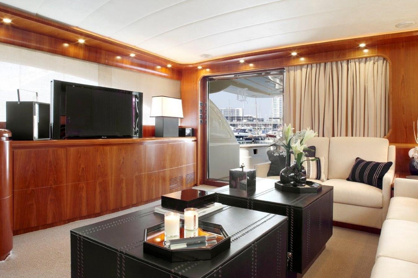 a living room with a tv and a coffee table aboard BARBASILDA Yacht for Sale