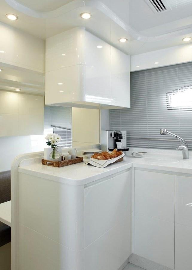 a kitchen with white cabinets aboard BARBASILDA Yacht for Sale