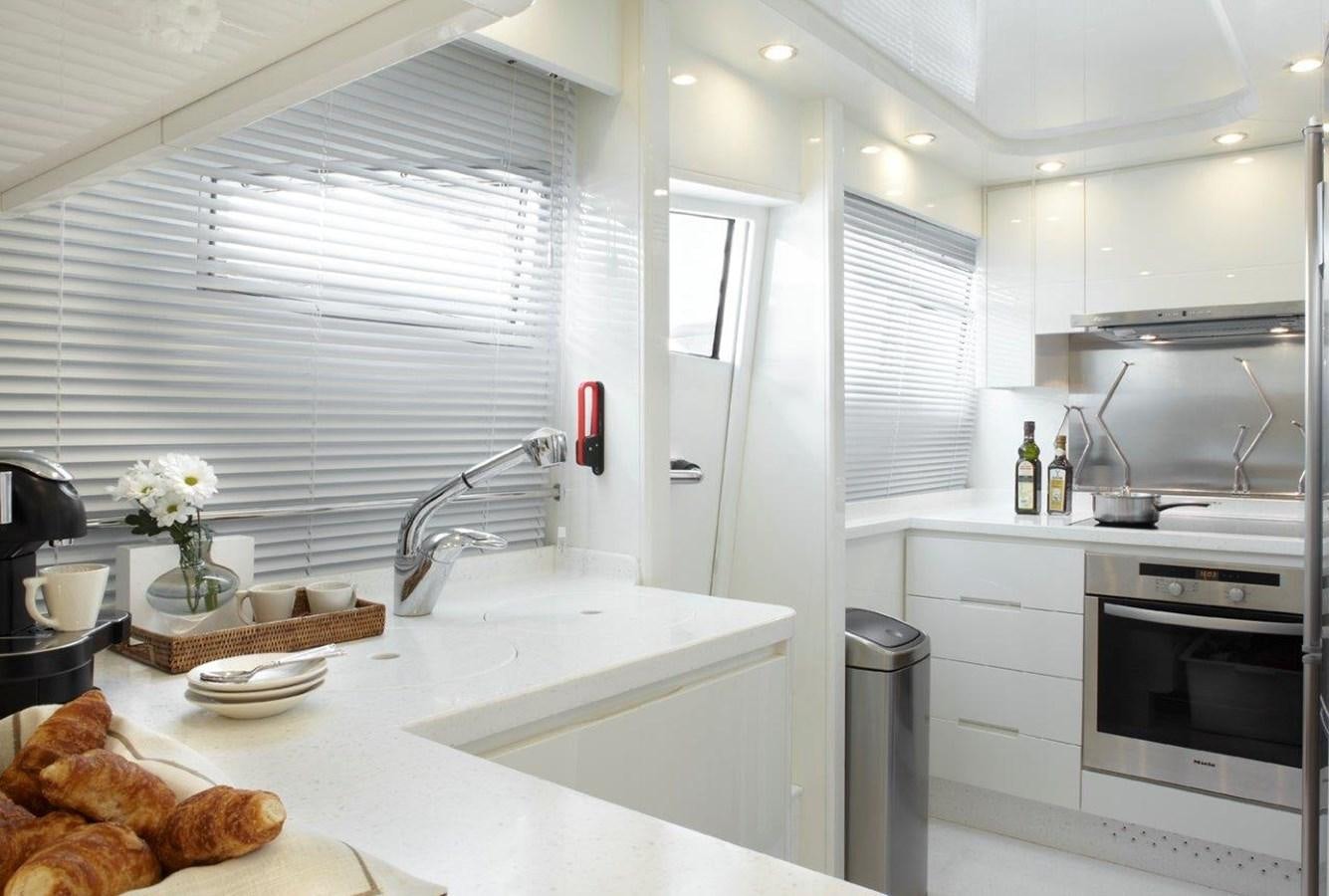 a kitchen with white cabinets aboard BARBASILDA Yacht for Sale