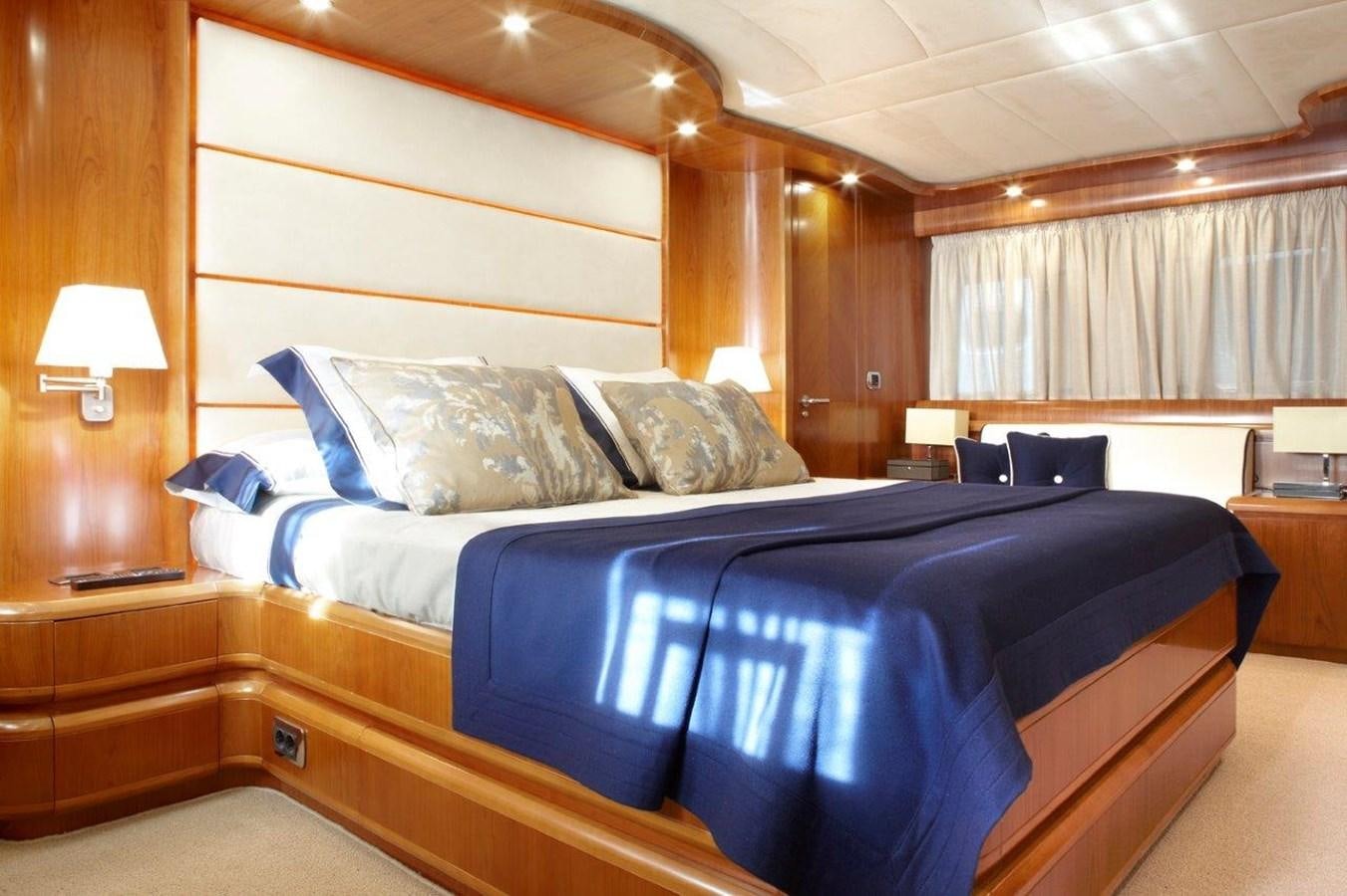 a bed with blue sheets aboard BARBASILDA Yacht for Sale