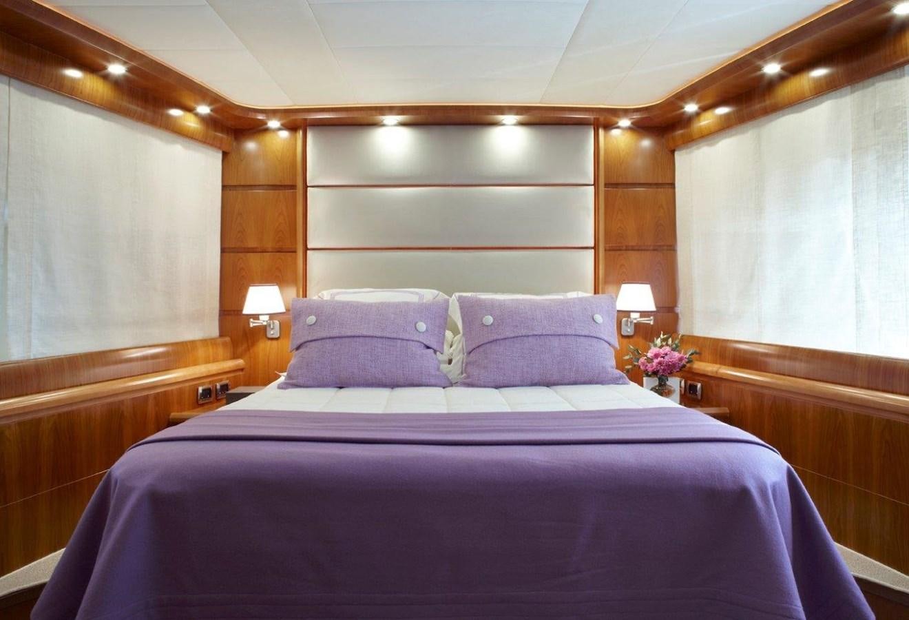 a bed with purple sheets aboard BARBASILDA Yacht for Sale