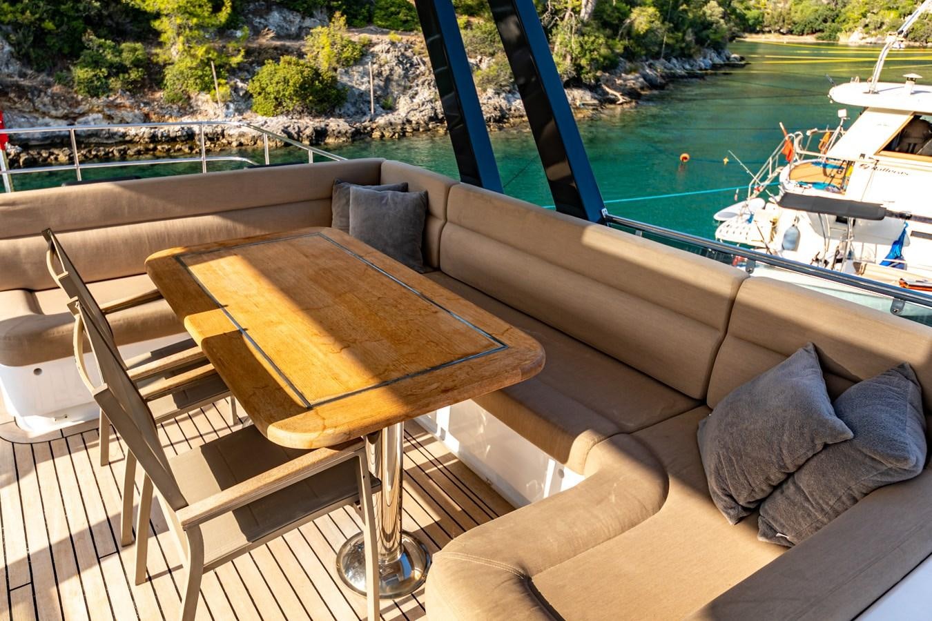 a table on a deck overlooking a body of water aboard WATER Yacht for Sale