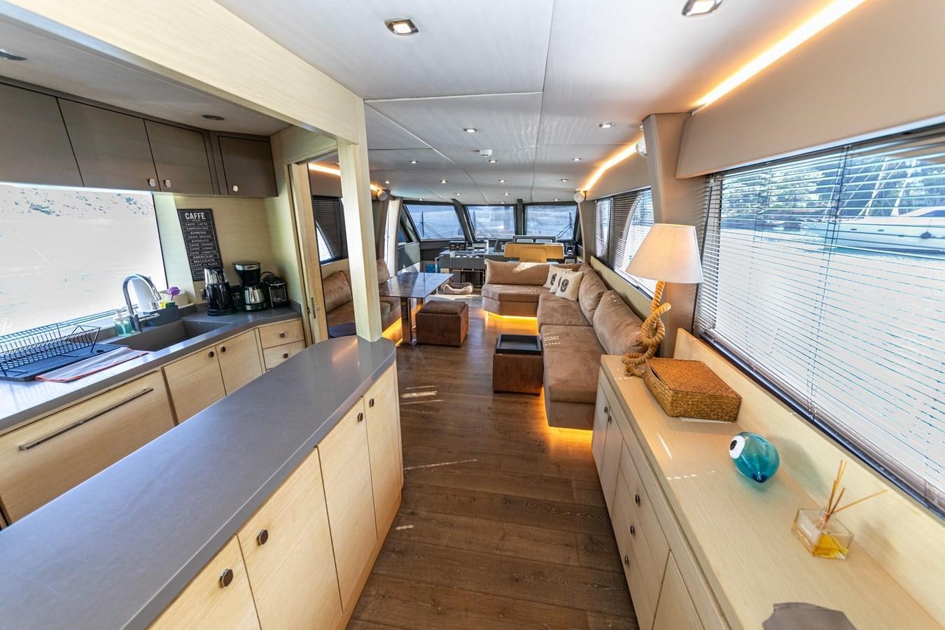 a large living room with a kitchen and living room aboard WATER Yacht for Sale