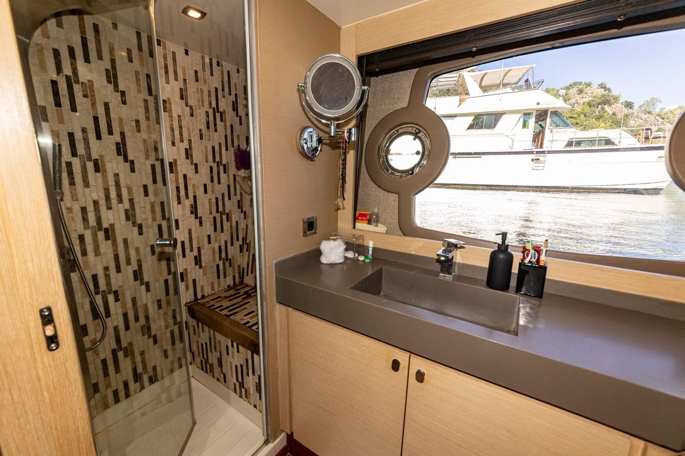 a kitchen with a sink and a large window aboard WATER Yacht for Sale