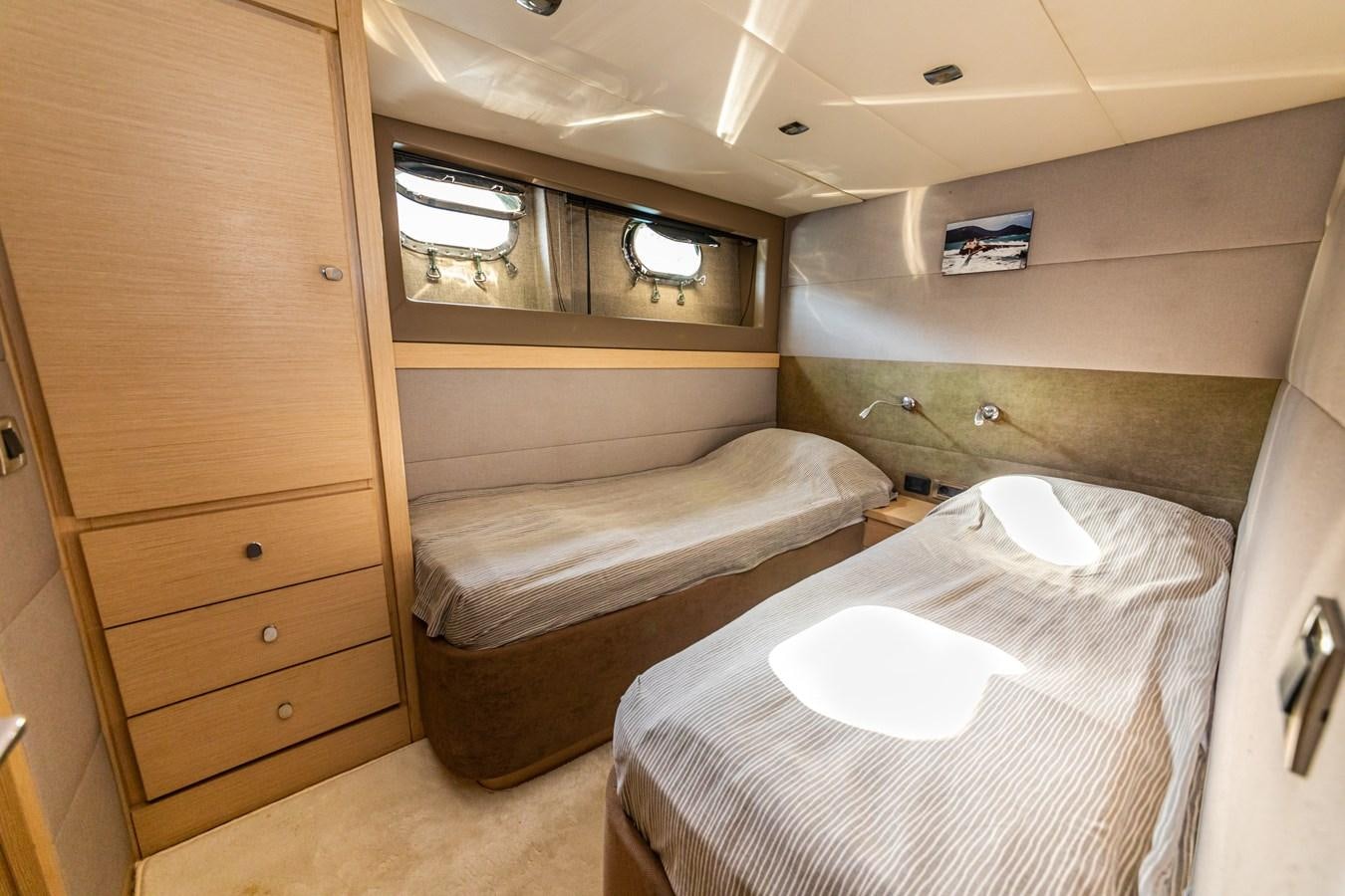 a room with a bed and a wooden cabinet aboard WATER Yacht for Sale