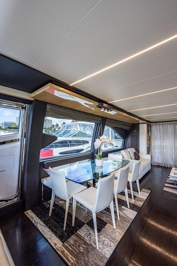 a dining room with a table and chairs aboard STAYSEA Yacht for Sale
