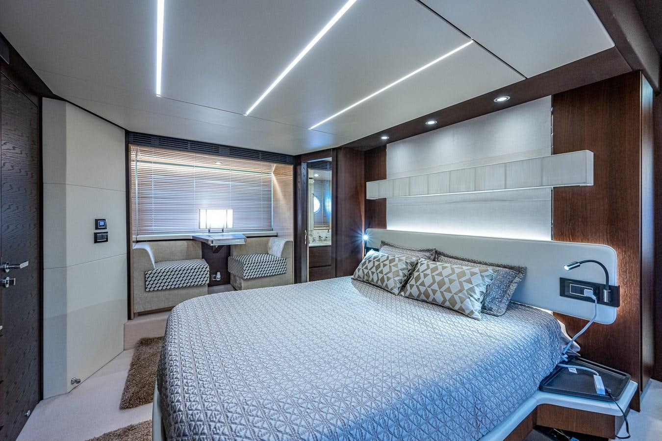 a bedroom with a bed and a desk aboard STAYSEA Yacht for Sale