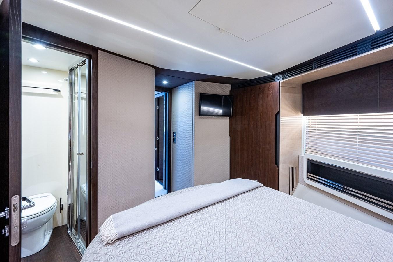 a bedroom with a bed and a window aboard STAYSEA Yacht for Sale
