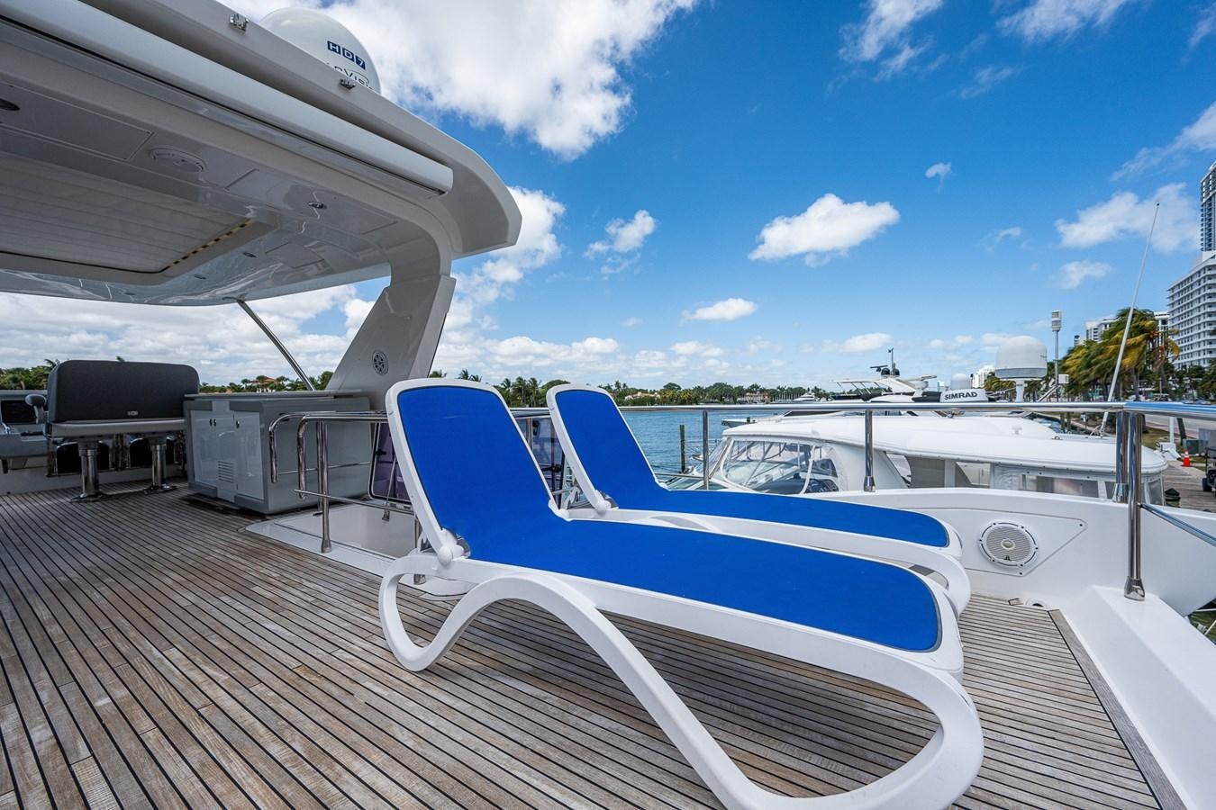 a deck with a boat and a chair on it aboard STAYSEA Yacht for Sale