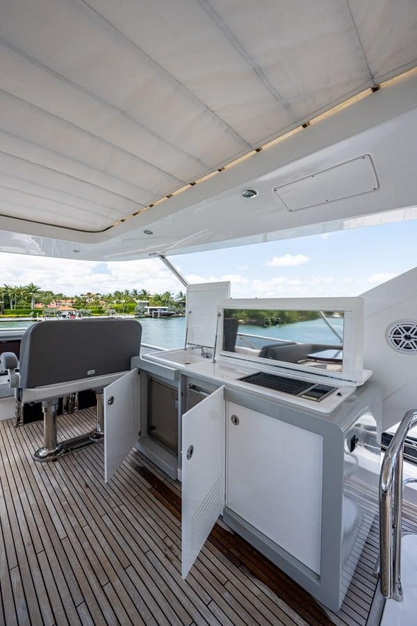a white kitchen with a large window aboard STAYSEA Yacht for Sale