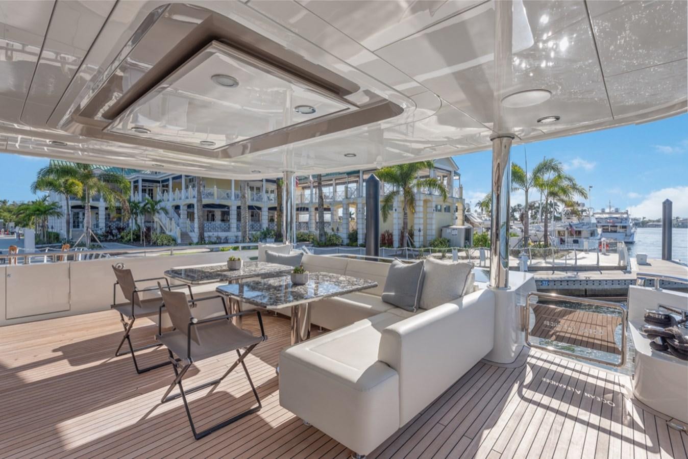 a large room with a couch and a table and chairs aboard EVERGLADE Yacht for Sale