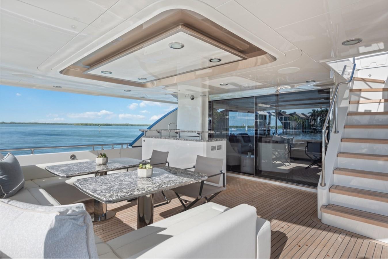 a room with a table and chairs aboard EVERGLADE Yacht for Sale