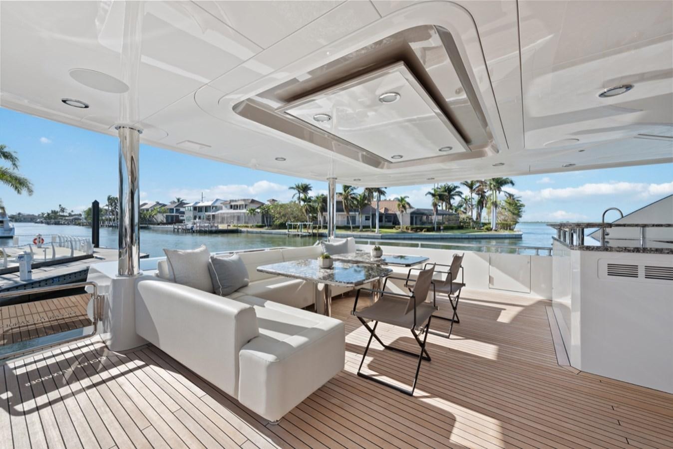 a large white lounge chair on a deck overlooking a large body of water aboard EVERGLADE Yacht for Sale