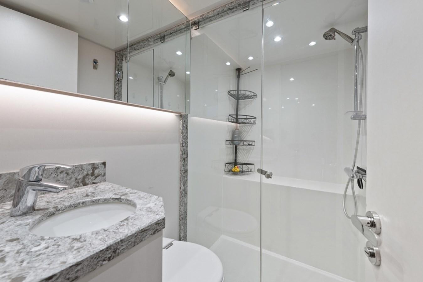 a bathroom with a glass shower aboard EVERGLADE Yacht for Sale