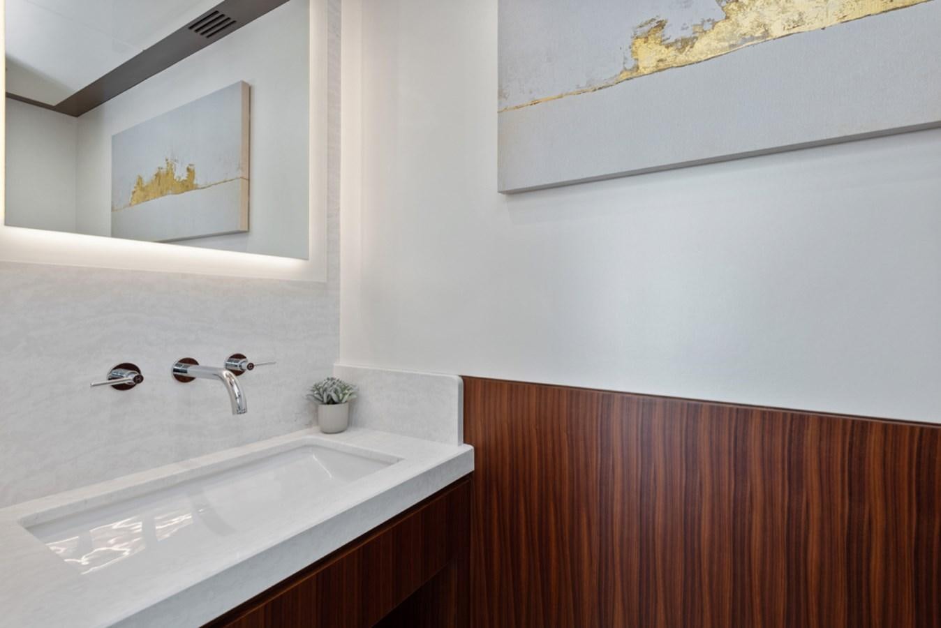 a bathroom with a sink and a mirror aboard EVERGLADE Yacht for Sale
