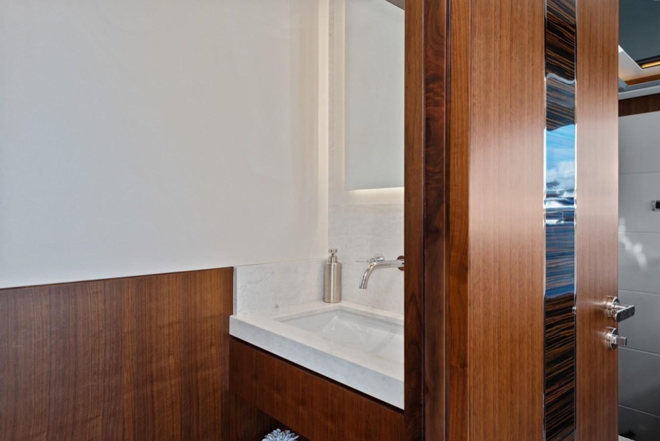 a bathroom with a sink and a mirror aboard EVERGLADE Yacht for Sale