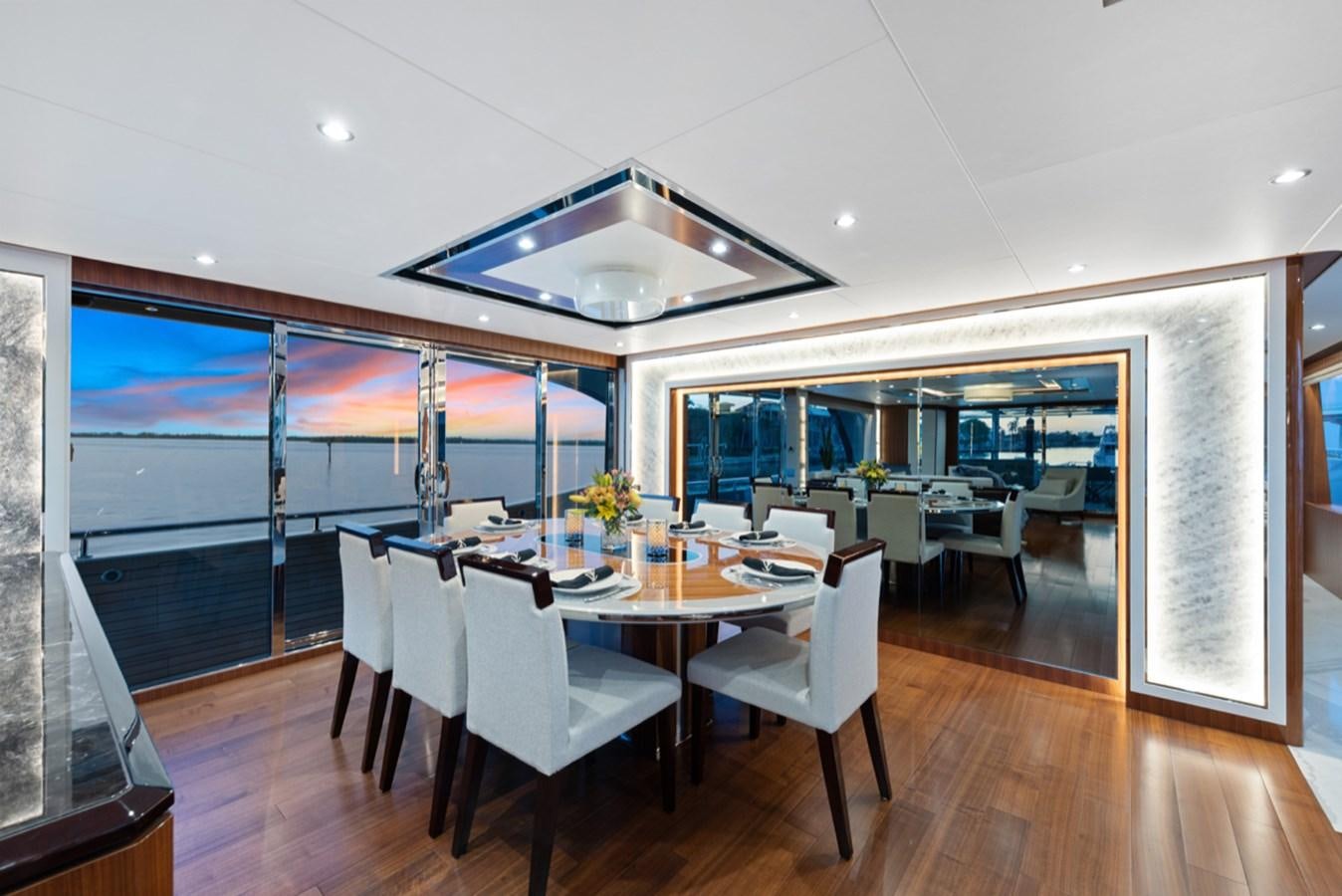 a room with a table and chairs aboard EVERGLADE Yacht for Sale