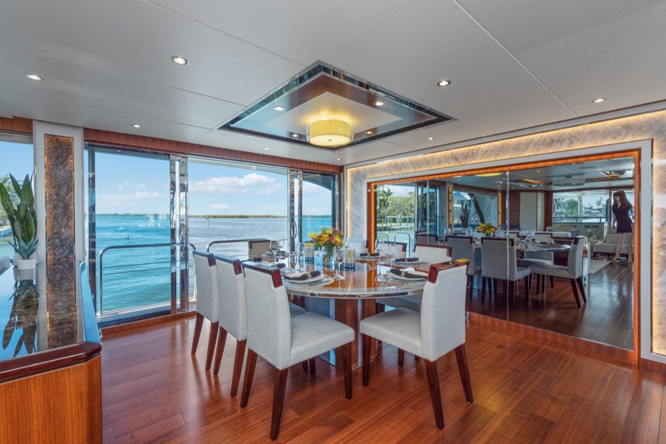 a dining room with a large window aboard EVERGLADE Yacht for Sale