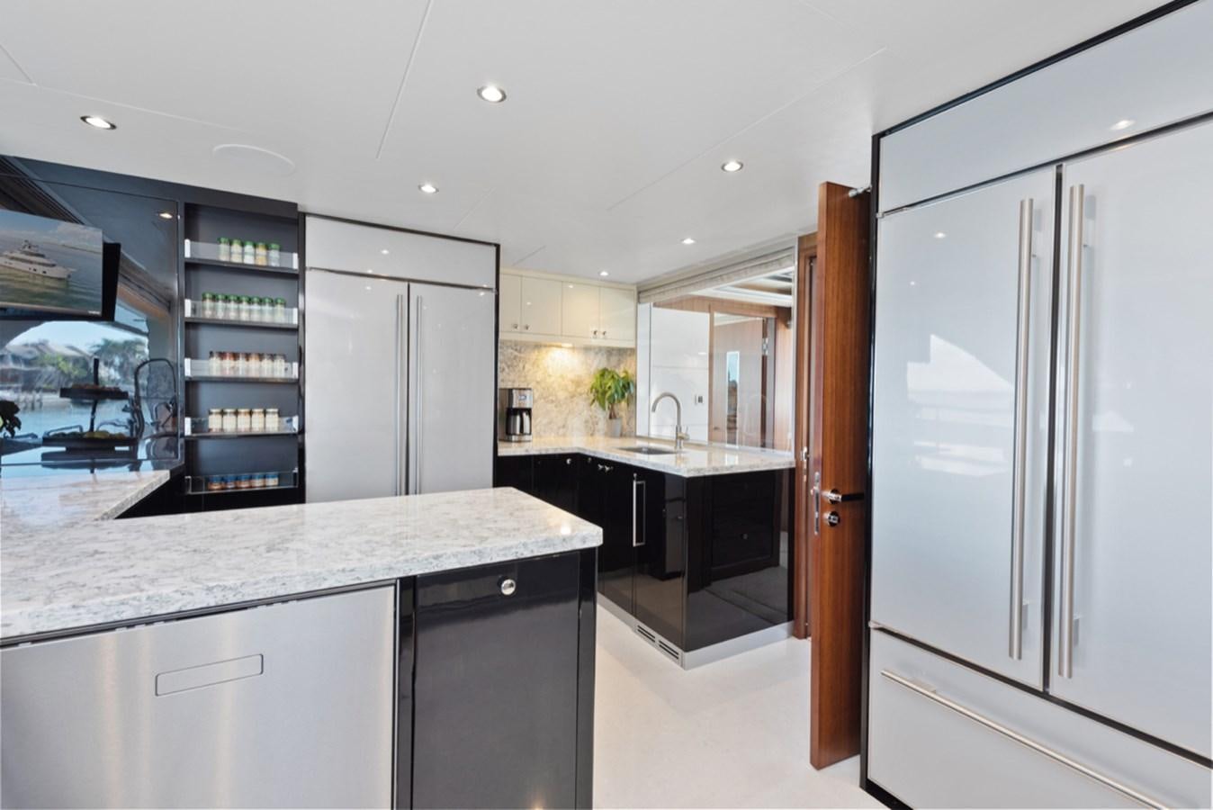 a kitchen with white cabinets aboard EVERGLADE Yacht for Sale