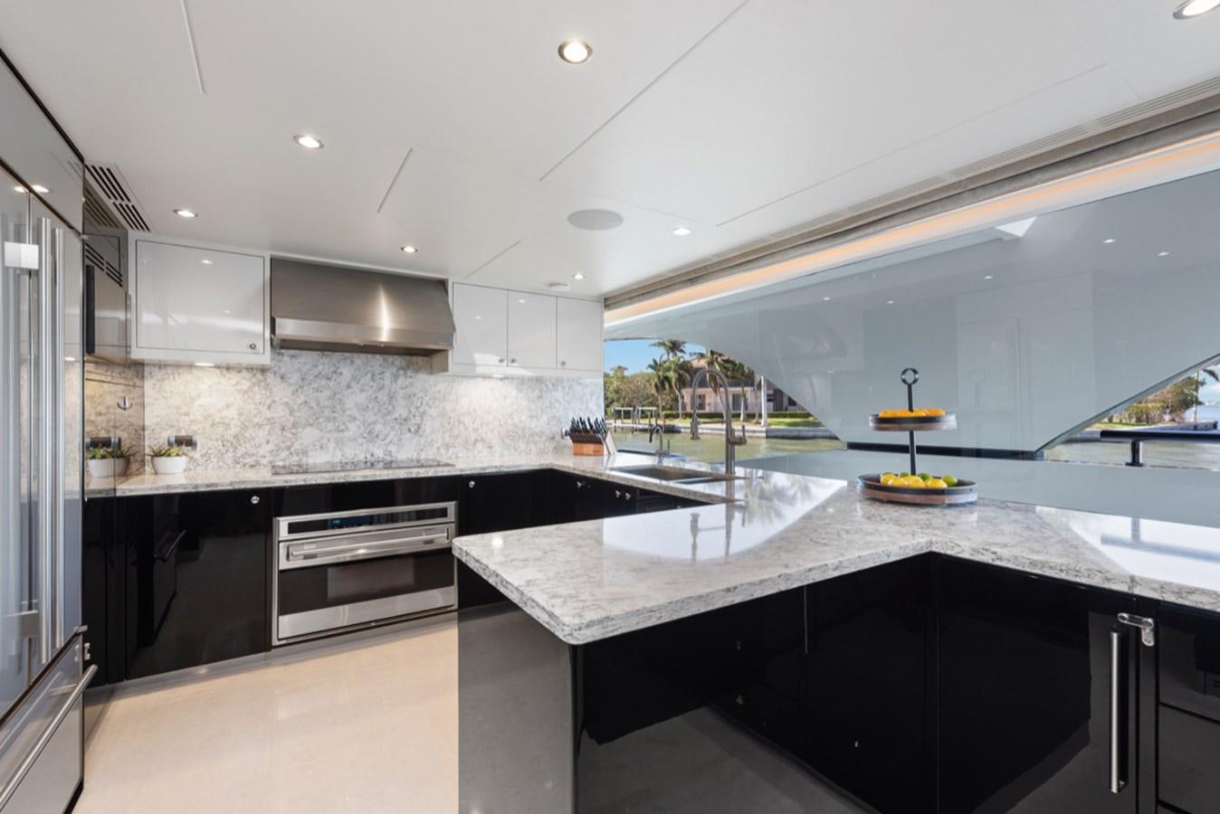 a kitchen with a large island aboard EVERGLADE Yacht for Sale