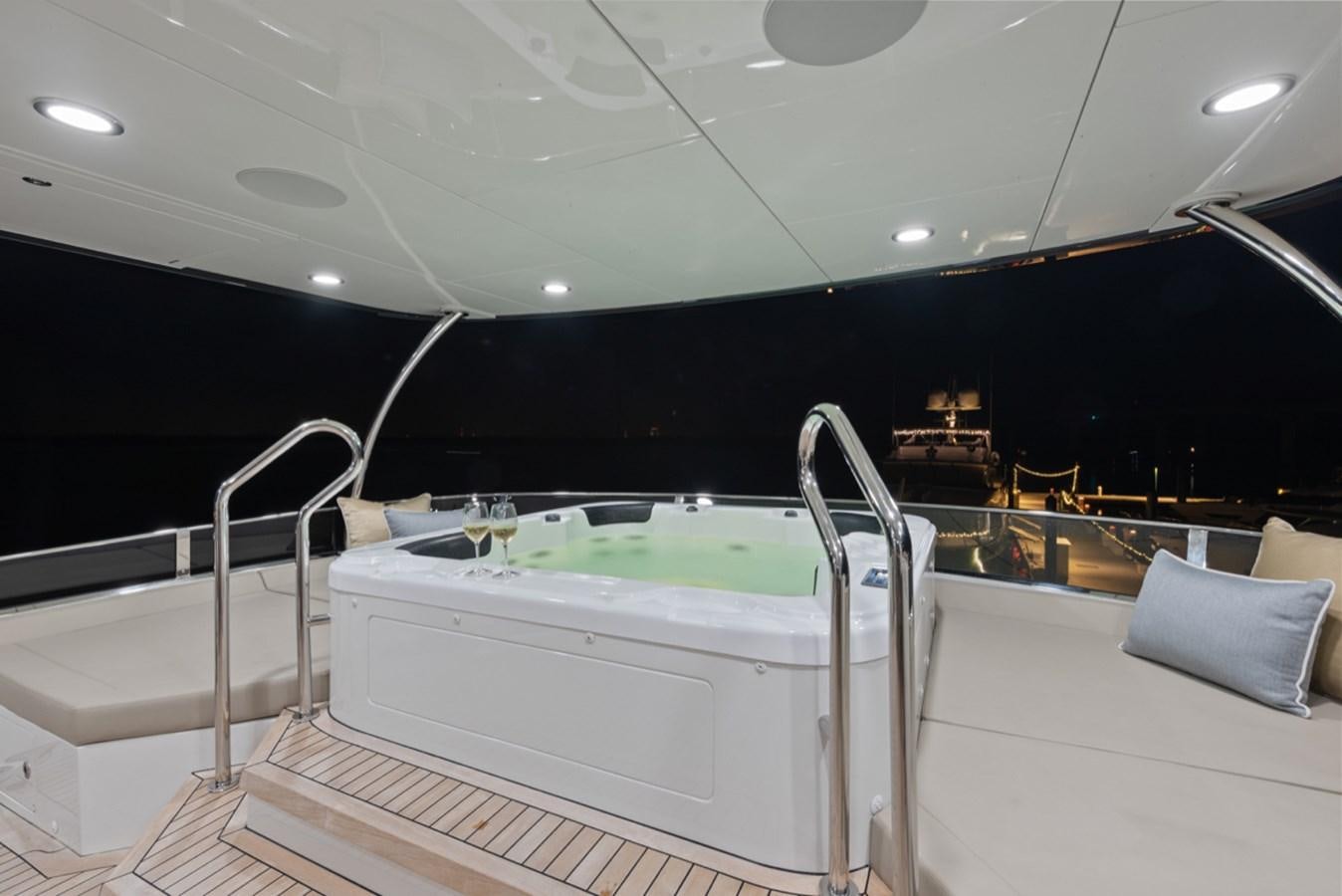 a large white boat in a large room with black walls aboard EVERGLADE Yacht for Sale