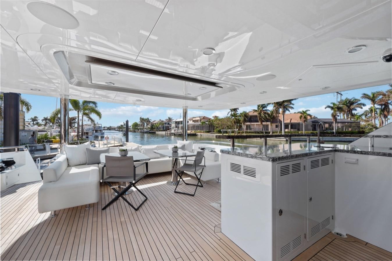 a large white room with a table and chairs and a large window aboard EVERGLADE Yacht for Sale