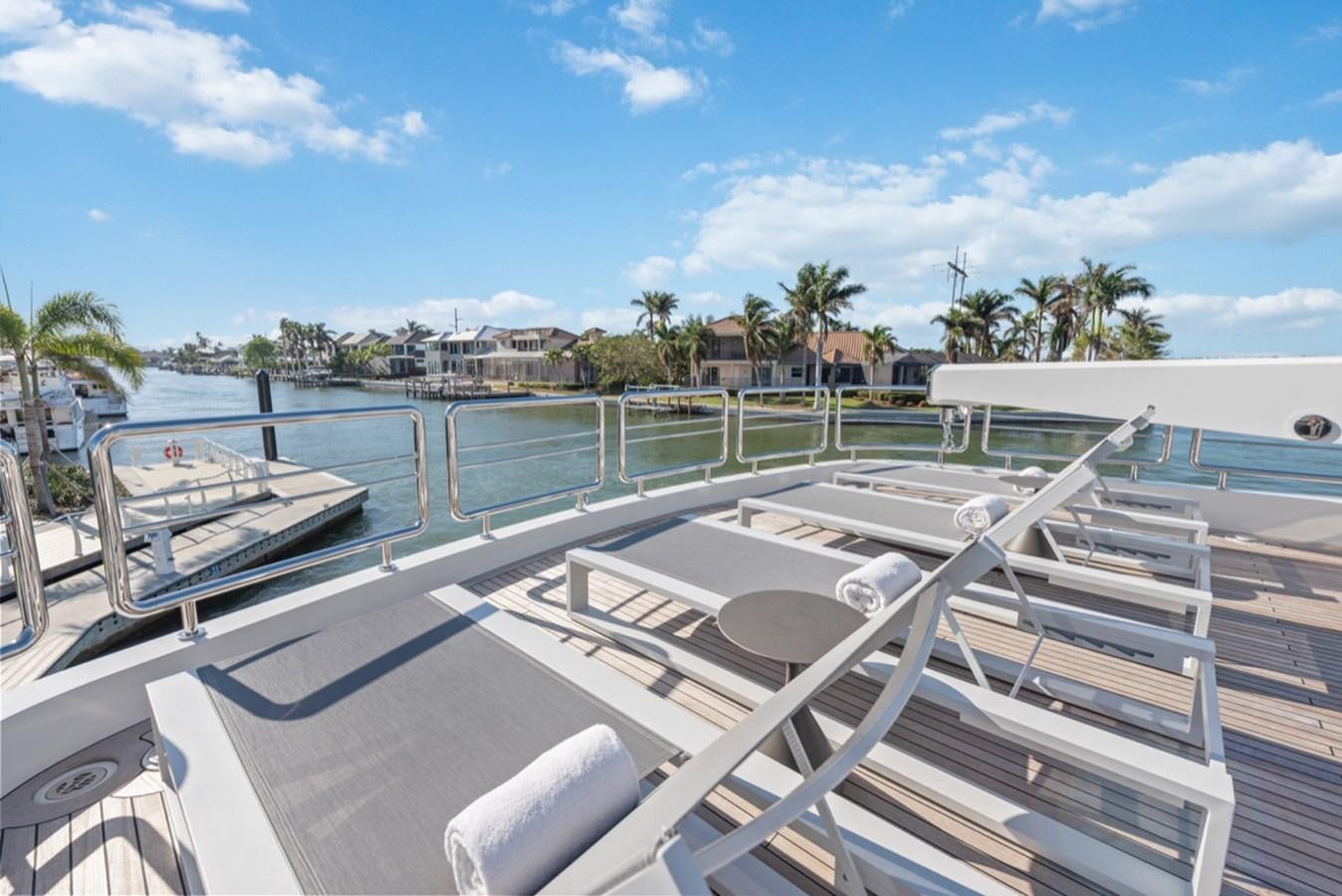 a deck with a pool and trees aboard EVERGLADE Yacht for Sale