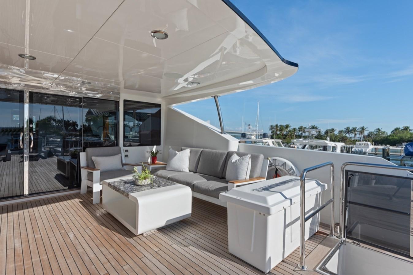 a room with a couch and a table aboard EVERGLADE Yacht for Sale