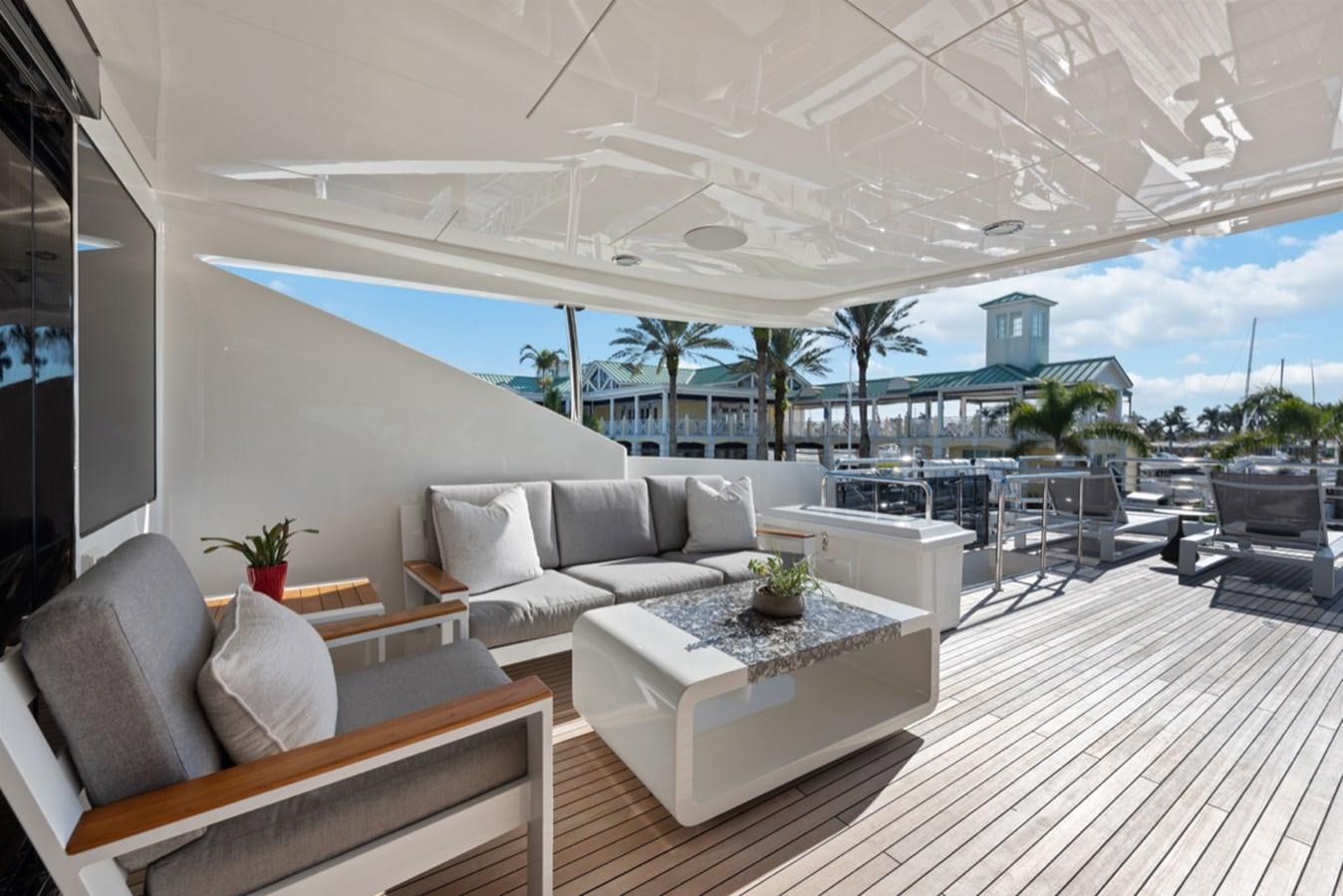 a large living room with a large patio and a large swimming pool aboard EVERGLADE Yacht for Sale