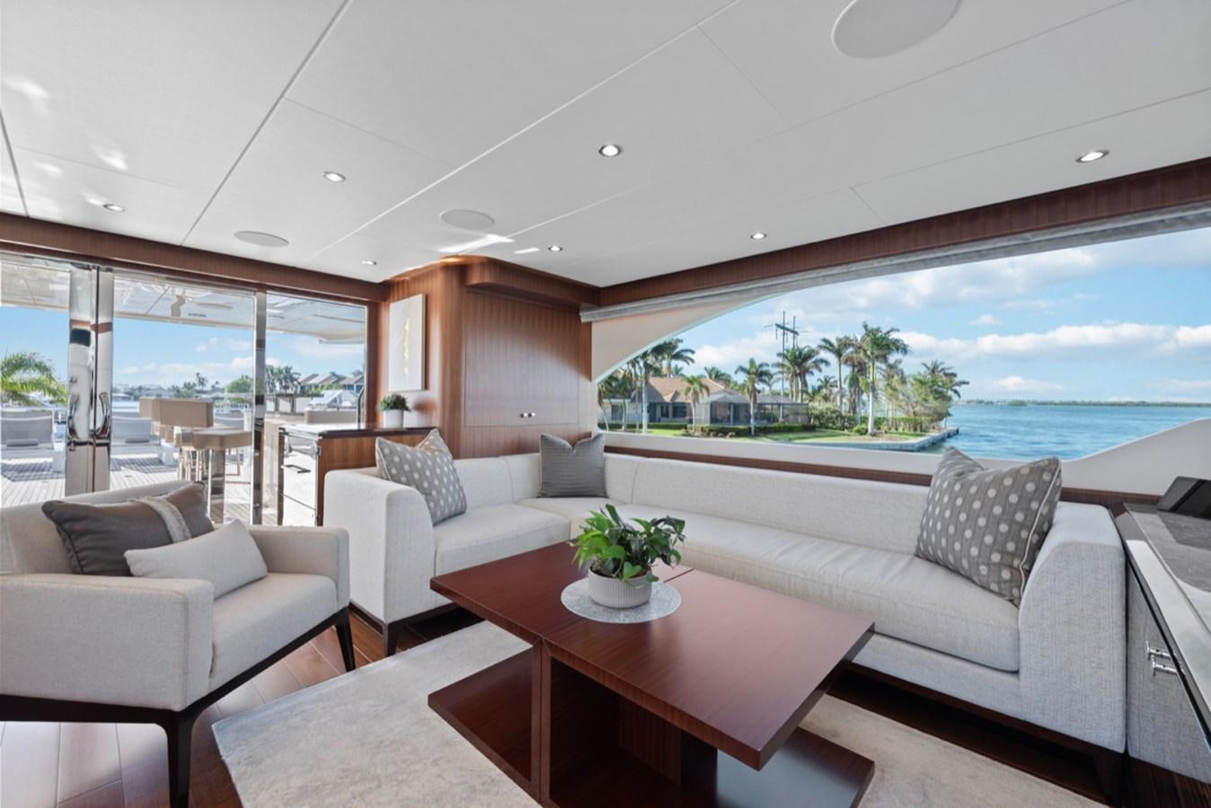 a living room with a large window aboard EVERGLADE Yacht for Sale