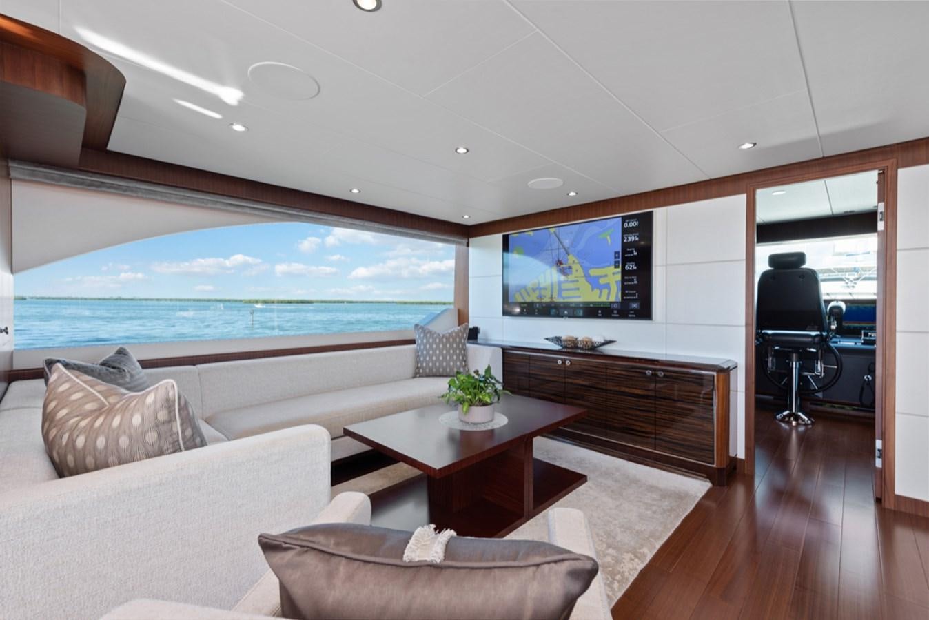 a living room with a large tv aboard EVERGLADE Yacht for Sale