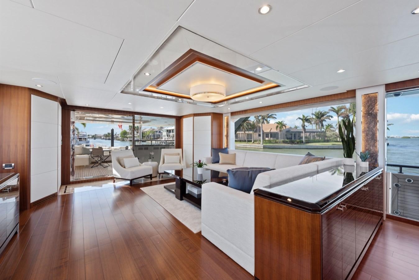 a large living room with a large open roof aboard EVERGLADE Yacht for Sale