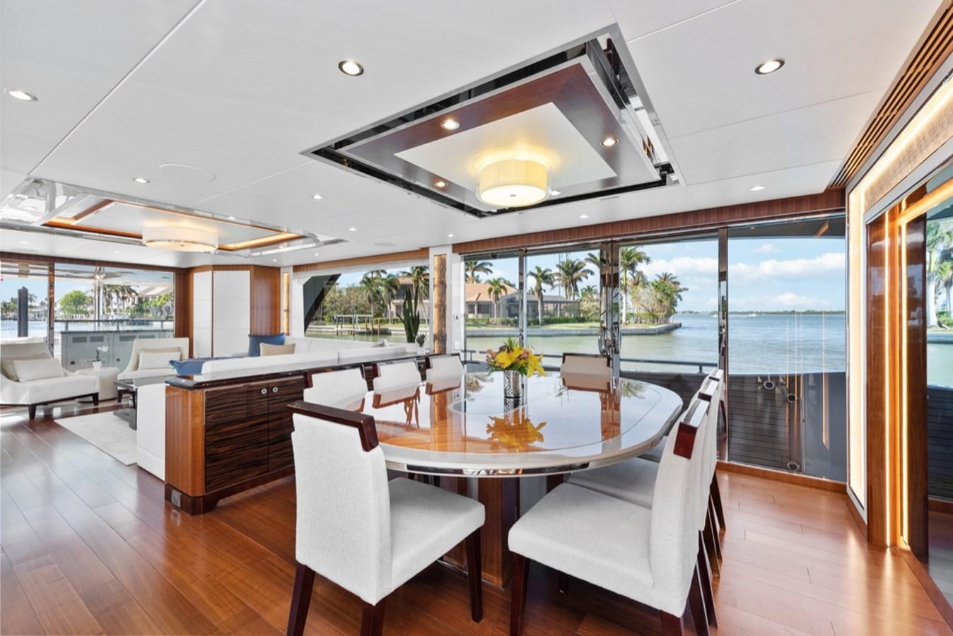 a large room with a table and chairs aboard EVERGLADE Yacht for Sale