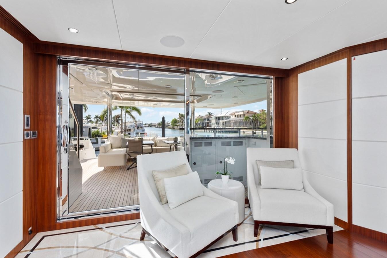 a room with a couch and a table and chairs aboard EVERGLADE Yacht for Sale